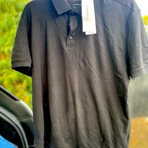 Brand new Calvin Klein Polo Tshirt. Large grey in color